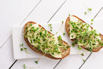 a sandwich with green young sprouts, micro greens and mozzarella, a healthy and healthy snack