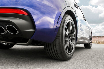 Car on sky background. Car wheels close up on a background of asphalt. Car tires. Car wheel...