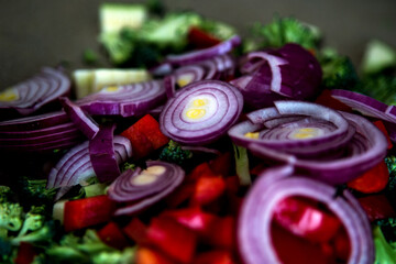 close-up of fresh cut onions, broccoli, zuccini and bell pepper