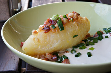 Cepelinai (zeppelin) with sour cream, cracklings and and green onion. T © troyka