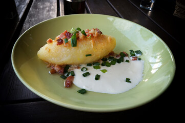Cepelinai (zeppelin) with sour cream, cracklings and and green onion. T