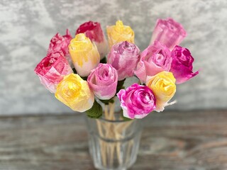 Roses from paper napkins are painted in bright colors, in a glass glass, diy
