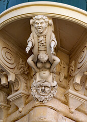 VALLETTA, MALTA - NOVEMBER 16TH 2019: A corbel sits on the corner of the Grand Masters Palace in St Georges Square it was intended stop passers by staring too long at the palace © Anthony