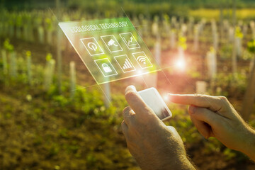 Technological image of agriculture with man in field with mobile phone viewing applications on...