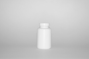 Photo of one plastic can for package pills and vitamins for people who lead healthy way of life &ndash; isolated on white background 