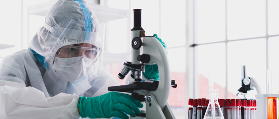 banner picture of scientist in personal protective equipment or ppe doing research and experiment...
