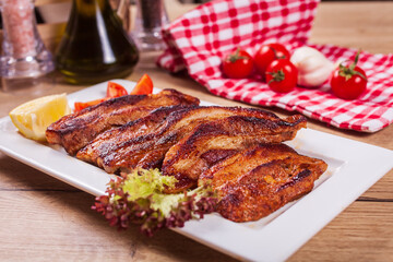 Close up of delicious boned ribs served on table