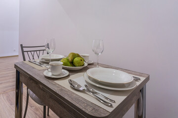 guest table in Interior of the modern luxure kitchen in studio apartments in minimalistic style with green color