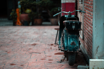 Vintage motorcycle parked beside the building