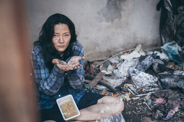 poor people,homeless or beggar begging for help sitting at dirty slum.concept for poverty...