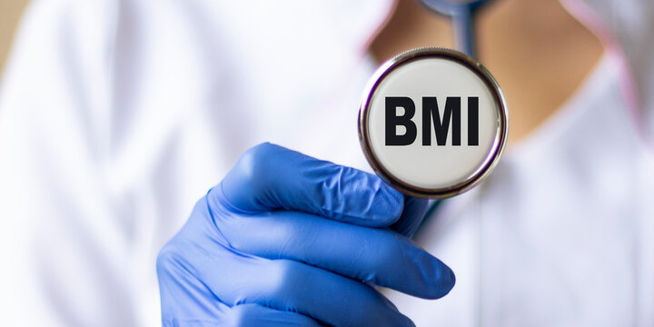 Doctor's hand in a medical glove holds a phonendoscope with text DMI. Medical concept