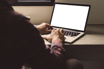 computer mockup image blank screen with white background for advertising,hand woman work using laptop contact business search information on desk at coffee shop.marketing and creative design