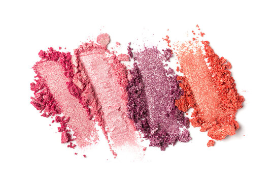 Close-up of make-up swatches. Smears of crushed shiny pink, red and purple eye shadow