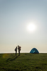 Couple with a tent on top of mountain - 353879623