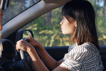 Asian woman driving a car