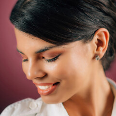 Emotions Love. Face of a beautiful happy young woman in love, studio portrait, pink background