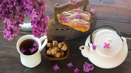 old iron as a decor for tea in the garden with lilac flowers