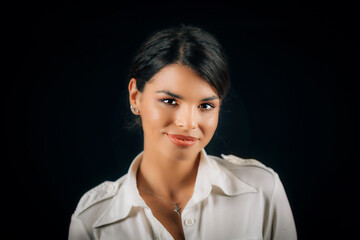 Emotion Love. Face of a beautiful happy young woman in love, studio portrait, black background