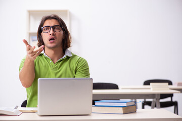 Young male student in the classroom