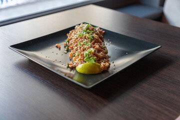 Close-up plate with rice and seafood and onion professionally served