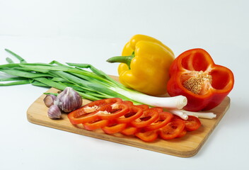 Delicious cuisine. Fresh vegetables on a wooden board, sliced for salad