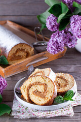 Sponge cake roll with cream in a plate
