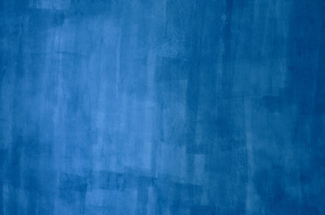 Blue background painted by brush on the white wall, blurred.