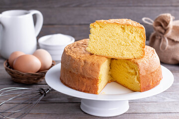 Homemade round sponge cake or chiffon cake on white plate so soft and delicious with ingredients:...