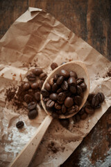 
wooden spoon with coffee beans on kraft paper