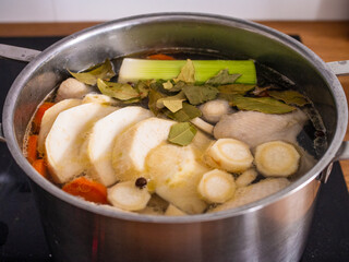 Broth - boiling chicken soup in pot

