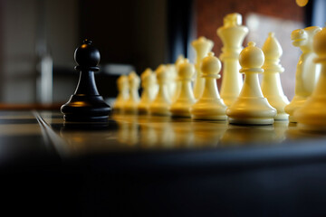 Black Pawn Facing Against the White Pieces, Suitable for Business Concept.