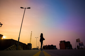 Girl under a colorful sunset  - 353883886