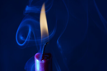 Candle with smoke and flame photographed in the studio with color foils before the flashes