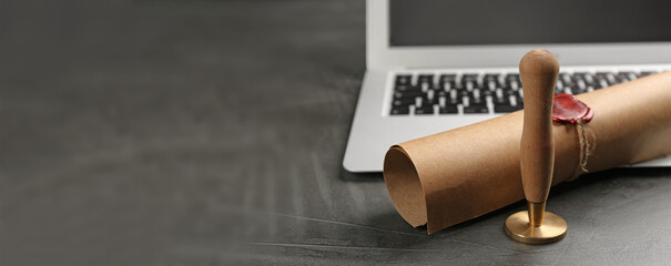 Notary's public pen and sealed document near laptop on grey stone table, space for text. Banner...
