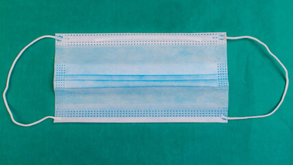 Medical mask on a green background