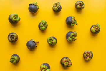 mangosteen fruit of Thailand on yellow background. soft focus.