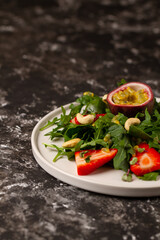 Salad with arugula,spinach, strawberries, passion fruit and cashew