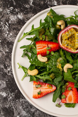 Salad with arugula,spinach, strawberries, passion fruit and cashew