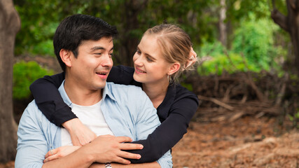 Young couple is hugging and sitting close in the park