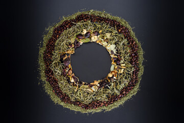 Fototapeta na wymiar herbal tea leaves with powder around; sumac, mint, daisy, cinnamon and thyme on black background, circle shape and blank circle on middle for logos