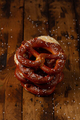 German Brezel pretzel with salt on wooden background