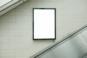 Small billboard beside the escalator.