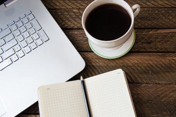 Obraz na płótnie Canvas Coffee table with laptop and notebook