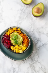 Healthy vegan lunch bowl. Avocado,lentil, mango,beet and chickpeas. Vegetables salad. Top view