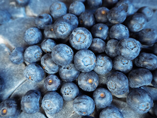 a bunch of blue blueberries on a stone background close up