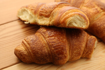 French croissants on a wooden board. 