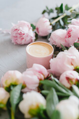 Fototapeta na wymiar Coffee and flowers. Stylish composition of cappuccino and peonies.