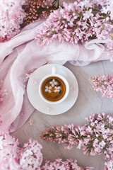 Flowers and coffee. Lilac and coffee, a beautiful composition. Flat lay. Flower concept.