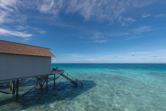 Villa room in the ocean with stairs to walk down to swim. © 9Bon