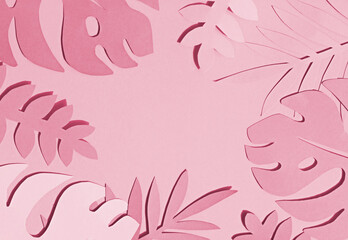 Toned photo of hand cut paper tropical plants leaves on the pink background. Summer concept Top...